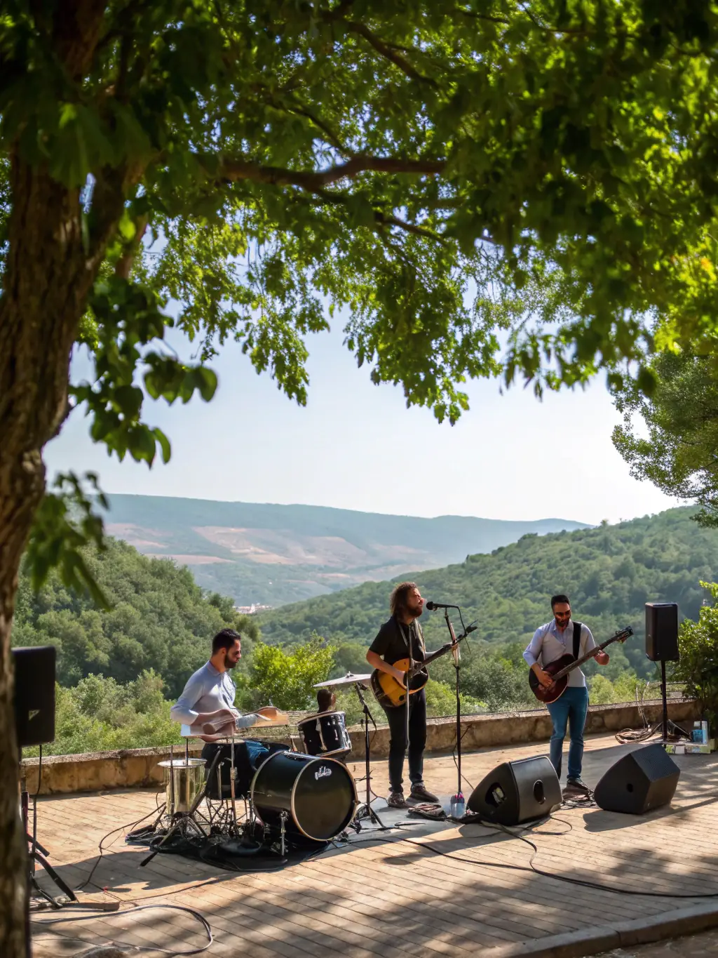 A vibrant image of a concert series event, featuring a string quartet performing on an outdoor stage with a picturesque Luberon backdrop, capturing the essence of AML's commitment to accessible live music.